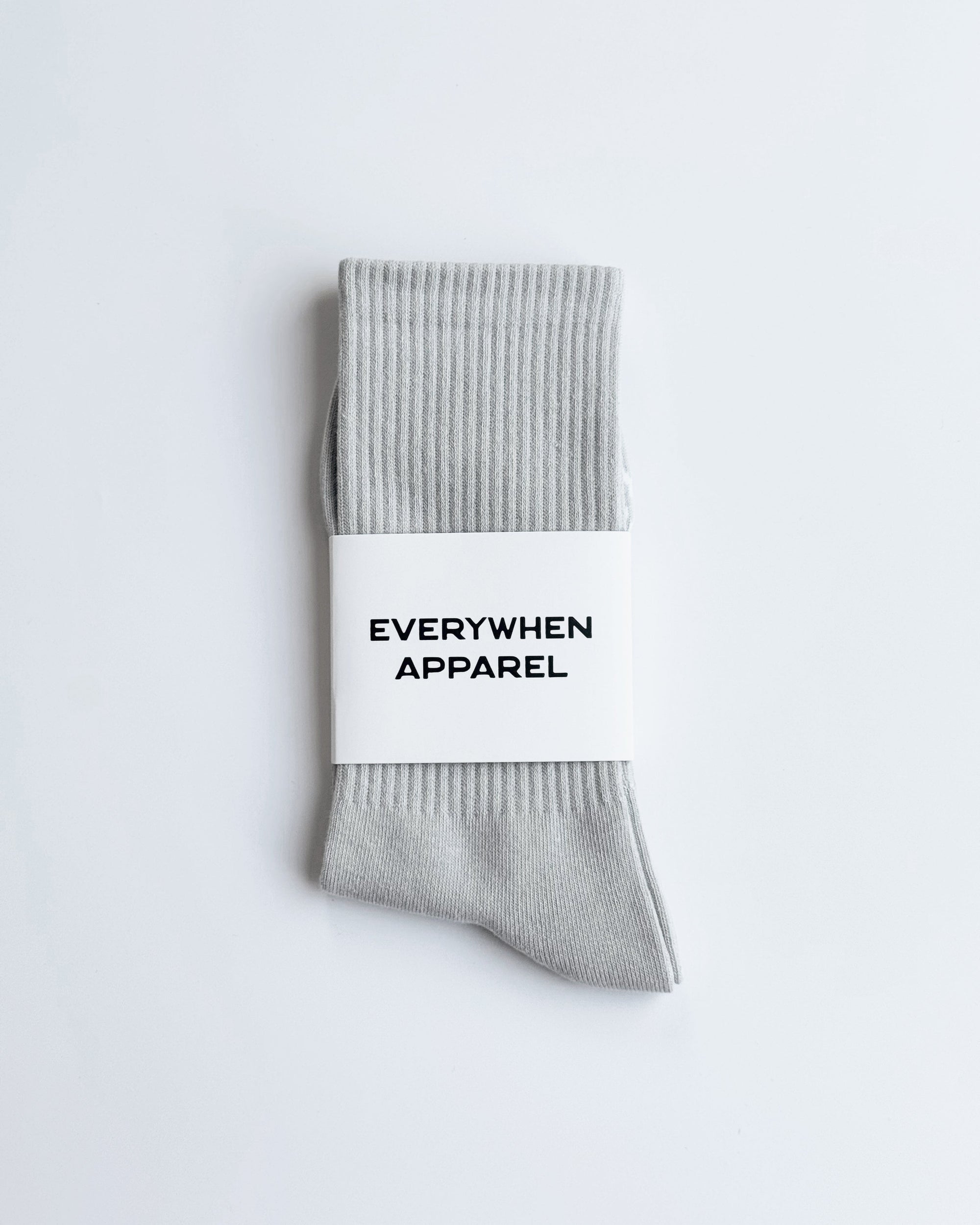 Gray sock with a white label on a light gray background
